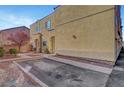 Tan two-story townhome with private parking and landscaping at 3929 Pepper Thorn Ave # 101, North Las Vegas, NV 89081