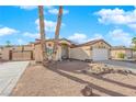 Single-story house with a gated entry and mature palm trees at 429 Nancy Dr, Henderson, NV 89015