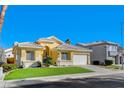 Single-story house with a two-car garage and green lawn at 4532 Laguna Vista St, Las Vegas, NV 89147