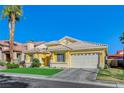 Single-story house with a two-car garage and palm trees at 4532 Laguna Vista St, Las Vegas, NV 89147