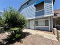 Charming exterior of a two-story townhouse with blue siding and a well-manicured front yard at 5340 Silvermist Ct # 103, Las Vegas, NV 89122