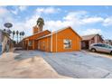 Orange house with a driveway and street view at 5453 Requa Ave, Las Vegas, NV 89110