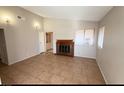 Bright living room featuring a fireplace and tile floors at 5453 Requa Ave, Las Vegas, NV 89110