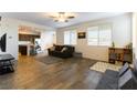 Open living room with hardwood floors, and a view into the kitchen at 5824 Petrified Tree Ln, North Las Vegas, NV 89081