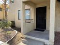 Condo entrance with black door and small patio at 601 Cabrillo Cir # 323, Henderson, NV 89015