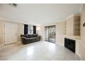 Living room with tile floors, fireplace, and sliding glass door to patio at 601 Cabrillo Cir # 323, Henderson, NV 89015