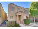 Beige two-story house with peach accents, two-car garage, and landscaping at 6285 Crusted Dome Ct, Las Vegas, NV 89139