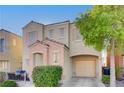 Tan two-story house with peach accents and a two-car garage at 6285 Crusted Dome Ct, Las Vegas, NV 89139