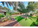 Artificial turf lawn, stone pathway, and desert landscaping at 6640 Palmyra Ave, Las Vegas, NV 89146