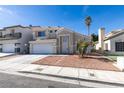 Charming two-story home featuring a well-maintained lawn, palm trees, and a two-car garage at 7233 Eaglegate St, Las Vegas, NV 89131