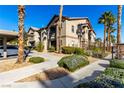 Condo building exterior with landscaping and walkway at 8250 N Grand Canyon Dr # 2073, Las Vegas, NV 89166