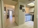 Bright hallway with tile flooring, connecting to the kitchen and living room at 833 Aspen Peak Loop # 1014, Henderson, NV 89011