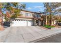 Two-story house with a three-car garage and mature trees at 8600 Copper Falls Ave, Las Vegas, NV 89129