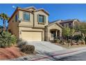 Beige two-story house with a two-car garage and mature landscaping at 9104 Little Horse Ave, Las Vegas, NV 89143