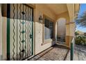 Front entrance with a decorative metal security door at 9104 Little Horse Ave, Las Vegas, NV 89143