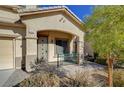 Front porch with decorative metal gate and brick flooring at 9104 Little Horse Ave, Las Vegas, NV 89143