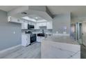 Updated kitchen boasts stainless steel appliances and a large quartz island at 936 Boulder Mesa Dr # 201, Las Vegas, NV 89128