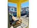 Relaxing balcony with outdoor furniture and view of neighboring townhomes at 965 Nevada State Dr # 1202, Henderson, NV 89002