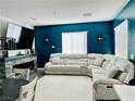 Comfortable living room with large sectional sofa and a stone fireplace at 965 Nevada State Dr # 1202, Henderson, NV 89002
