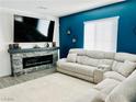Well-lit living room with a gray stone fireplace and a plush sectional sofa at 965 Nevada State Dr # 1202, Henderson, NV 89002
