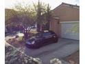 Attached garage with driveway and landscaping at 1173 Stormy Valley Rd, Las Vegas, NV 89123