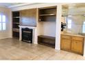 Living room with fireplace, built-in shelving, and wet bar at 1736 Williamsport St, Henderson, NV 89052