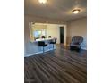 Living room with gray vinyl flooring, a rocker recliner, and kitchen island at 1920 Walnut Ave, Las Vegas, NV 89101