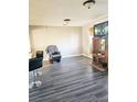 Living room with gray vinyl flooring, a recliner, and entertainment center at 1920 Walnut Ave, Las Vegas, NV 89101