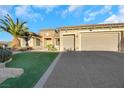 Single story house with three-car garage and artificial turf at 2080 Twin Falls Dr, Henderson, NV 89044