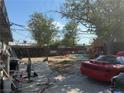 This shot of the backyard shows trees and an unfinished project at 2127 Crawford St, North Las Vegas, NV 89030