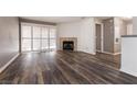 Living room with fireplace and wood-look flooring at 2200 S Fort Apache Rd # 2050, Las Vegas, NV 89117