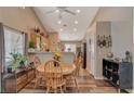 Open concept dining area with wood floors and kitchen view at 2715 Coral Cliffs Ct, North Las Vegas, NV 89031