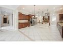 Spacious kitchen with island, stainless steel appliances, and dark wood cabinets at 2768 Liberation Dr, Henderson, NV 89044