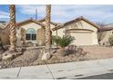 Single-story home with desert landscaping, a two-car garage, and a paved brick driveway at 3363 Blue Ribbon Downs St, Las Vegas, NV 89122