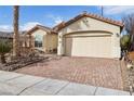 Single-story home with desert landscaping, a two-car garage, and a circular paved brick driveway at 3363 Blue Ribbon Downs St, Las Vegas, NV 89122