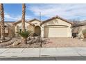 Charming single-story home featuring a two-car garage, desert landscaping, and a paved brick driveway at 3363 Blue Ribbon Downs St, Las Vegas, NV 89122