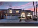 Two-story house with a three-car garage and landscaped front yard at 3925 Larkcrest St, Las Vegas, NV 89129