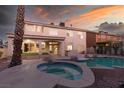 Inviting swimming pool and spa surrounded by a stone patio at 3925 Larkcrest St, Las Vegas, NV 89129