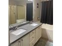 Main bathroom with double sinks, a shower, and a bathtub at 414 Maritocca Ave, North Las Vegas, NV 89031