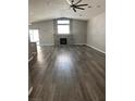 Bright living room with fireplace, vaulted ceilings, and new gray, wood-look vinyl plank flooring at 414 Maritocca Ave, North Las Vegas, NV 89031