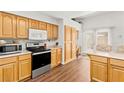 Kitchen with light wood cabinets, stainless steel appliances, and breakfast bar at 5112 Palm View Dr, Las Vegas, NV 89130