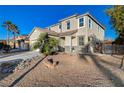 Two-story house with a palm tree and gravel landscaping at 6104 Talbot Springs Ct, North Las Vegas, NV 89081