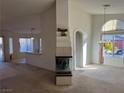 Spacious living room with a fireplace and views into the kitchen at 6256 Hill Haven Ave, Las Vegas, NV 89130