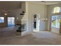 Bright living room featuring a fireplace and access to kitchen at 6256 Hill Haven Ave, Las Vegas, NV 89130