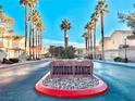 Boulder Ranch entrance featuring swaying palm trees and manicured landscaping, offering serene community living at 6449 Stone Dry Ave # 101, Henderson, NV 89011