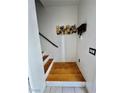 Entryway with wood flooring, art on the wall, a storage area, and stairs leading to the upper level at 6449 Stone Dry Ave # 101, Henderson, NV 89011