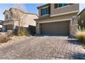 Brick paver driveway leading to a two-car garage at 7122 Rocket Launch St, North Las Vegas, NV 89084