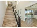 Modern light-toned wood staircase with metal railing at 8224 Skye Territory St, Las Vegas, NV 89166