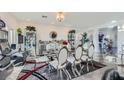 Open concept dining room with modern furniture and a large chandelier at 9045 Knots Estate St, Las Vegas, NV 89139