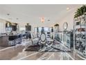 Elegant dining room features a large table, chandelier, and modern decor at 9045 Knots Estate St, Las Vegas, NV 89139